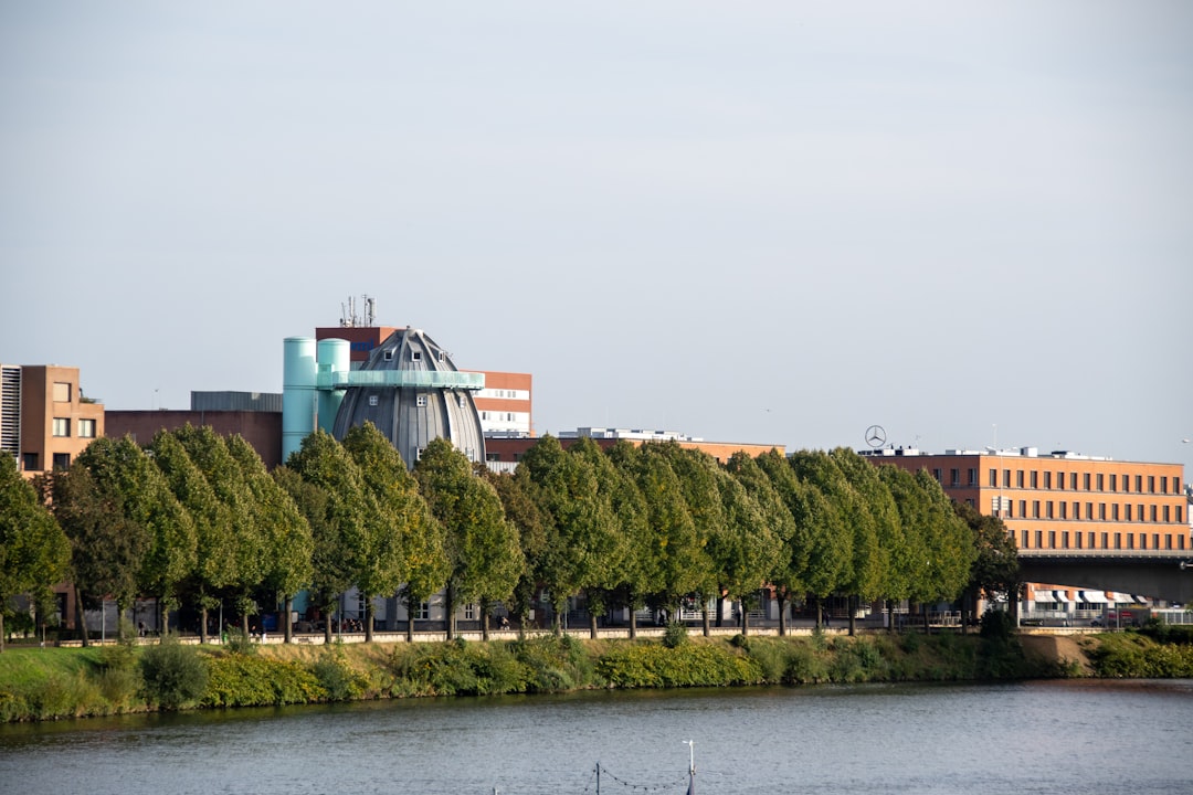 a large building with a tower next to a body of water